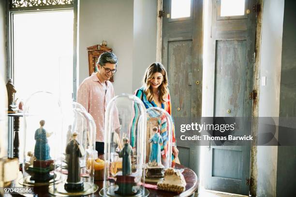 smiling couple wandering through small museum while on vacation - finding gray hair stock pictures, royalty-free photos & images