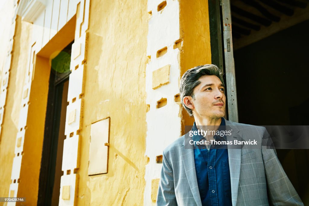 Portrait of businessman standing in doorway of hotel