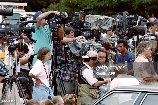 Photographers, television crews and reporters set up on July 31 in Atlanta, outside the apartment of Richard Jewell, a security officer who is being...