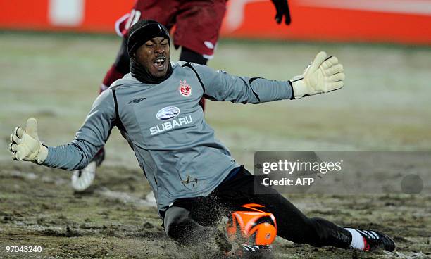 Hapoel Tel-Aviv's goalkeeper Vincent Enyeama stops the ball during his team's first leg UEFA Europa League round of 32 football match against...