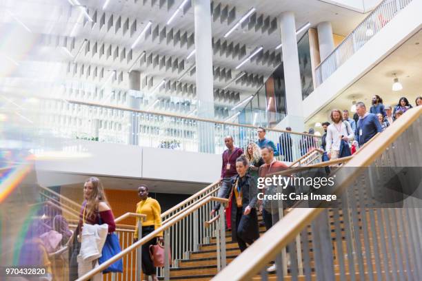 Business people descending office stairs