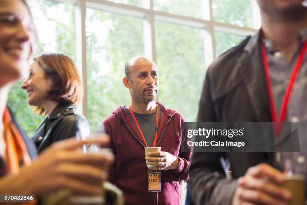 Businessman drinking coffee, networking at conference