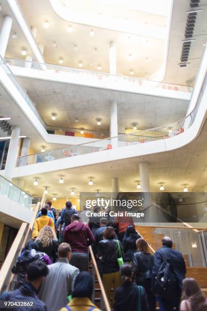 Business people ascending modern office stairs