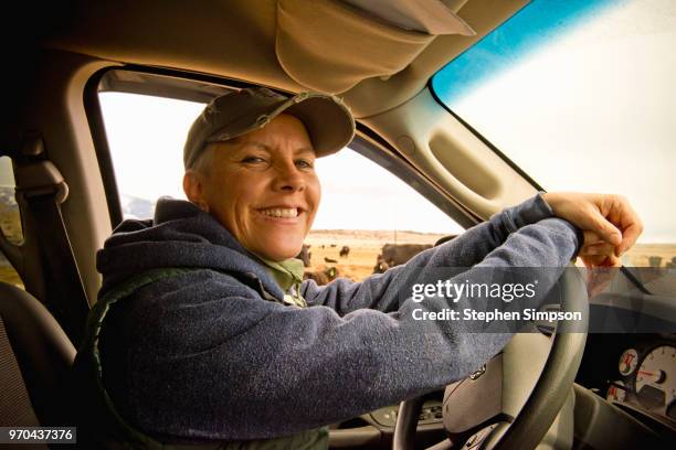 woman drives truck on montana ranch - country western outside stockfoto's en -beelden