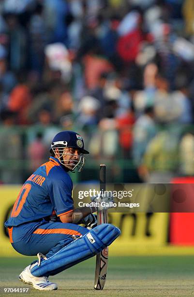Sachin Tendulkar of India takes a break as he rests on his haunches on his way to a record double century during the 2nd ODI between India and South...