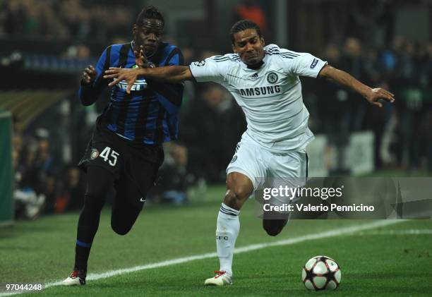 Mario Balotelli of Inter Milan competes for the ball with Florent Malouda of Chelsea during the UEFA Champions League round of 16 first leg match...