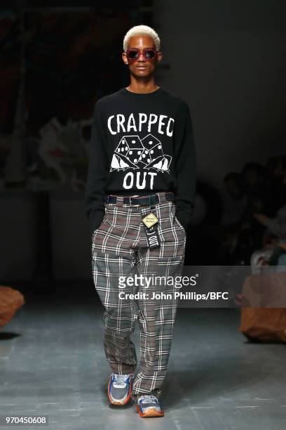 Model walks the runway at the Liam Hodges show during London Fashion Week Men's June 2018 at BFC Show Space on June 9, 2018 in London, England.