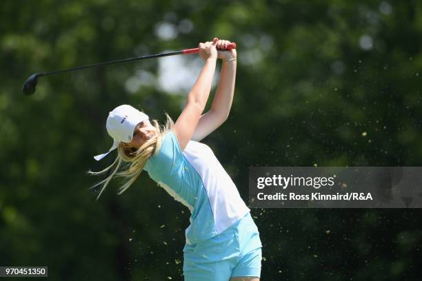 Annabell Fuller of the Great Britain and Ireland team plays her tee shot on the sixth hole in her match with Alice Hewson against Mariel Galdiano and...