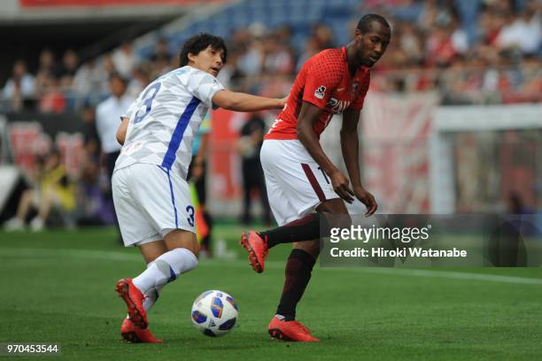 Byeon Jun Byum of Ventforet Kofu and Martinus of Urawa Red Diamonds compete for the ball during the J.League Levain Cup Play-Off second leg between...
