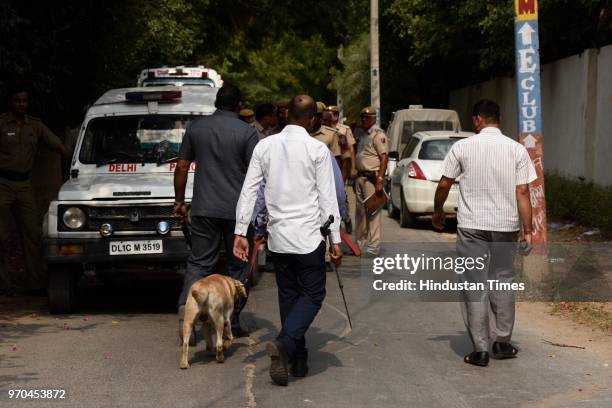 Police personnel inspect the site of an encounter between the Special Cell and a gang of criminals in the Fatehpur Beris Chanan Hola village, near...