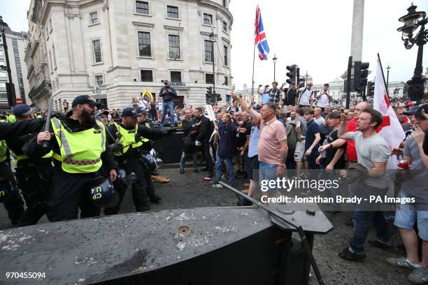 Police using batons hold back supporters of Tommy Robinson during their protest in Trafalgar Square, London calling for his release from prison.