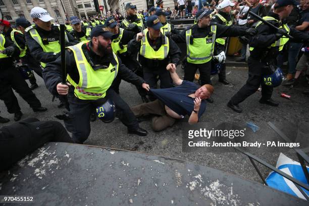 Police using batons hold back supporters of Tommy Robinson during their protest in Trafalgar Square, London calling for his release from prison.