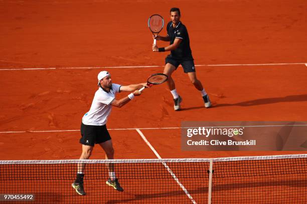 Mate Pavic of Croatia and Oliver Marach of Austria return the ball during the mens doubles final against Pierre-Hugues Herbert of France and Nicolas...