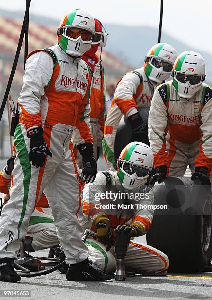 Force India pitcrew wait for Vitantonio Liuzzi of Italy and Force India to come in for a pitstop during Formula One winter testing at the Circuit De...