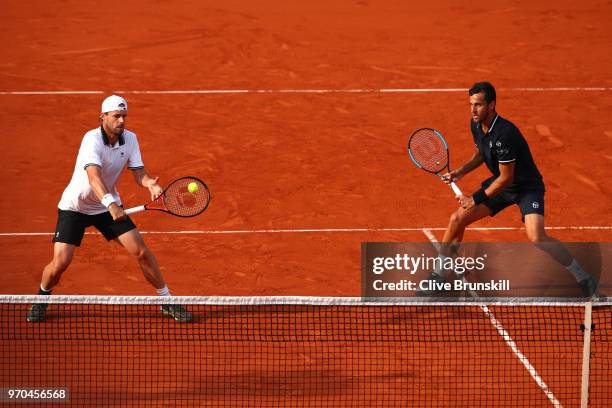 Mate Pavic of Croatia and Oliver Marach of Austria return the ball during the mens doubles final against Pierre-Hugues Herbert of France and Nicolas...