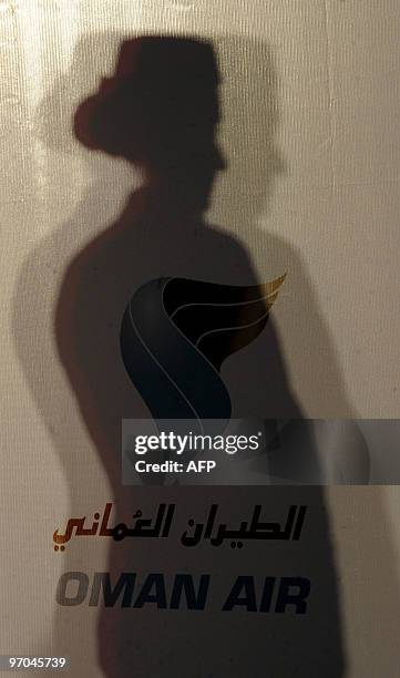 An Oman Air hostess casts a shadow on a wall during a press conference in Colombo on February 25 held to announce the airline's four weekly frequency...