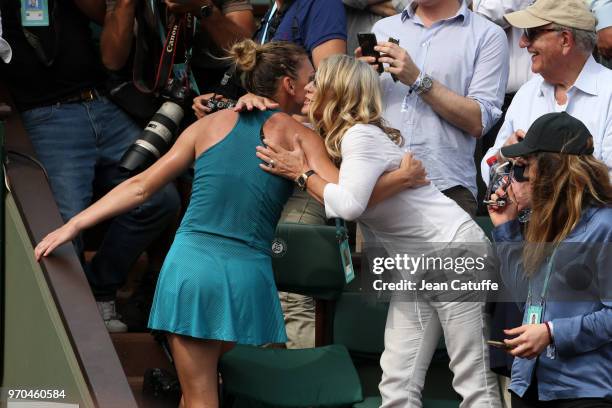 Winner Simona Halep of Romania is greeted by Nadia Comaneci in the stands after winning the French Open final on Day 14 of the 2018 French Open at...