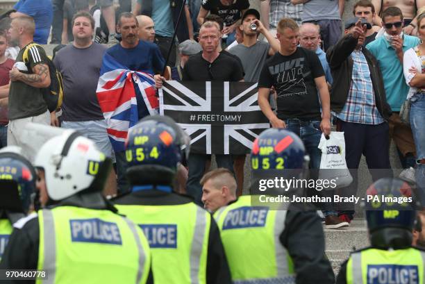 Police watch supporters of Tommy Robinson during their protest in Trafalgar Square, London calling for his release from prison.