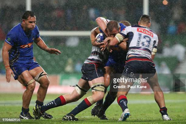 Chris Heiberg of the Force gets tackle by Sam Jeffries and Tom English of the Rebels during the World Series Rugby match between the Force and the...
