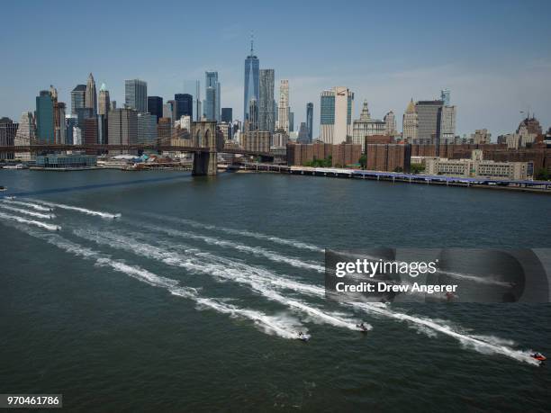 Jet skiers ride in the East River, June 9, 2018 in New York City. Hundreds of watersports enthusiasts from around the tri-state area joined what...
