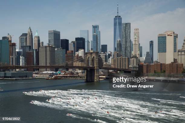 Jet skiers ride in the East River, June 9, 2018 in New York City. Hundreds of watersports enthusiasts from around the tri-state area joined what...