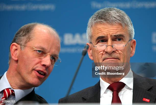 Kurt Bock, chief financial officer of BASF, left, speaks to Juergen Hambrecht, the company's chief executive officer, during a news conference in...