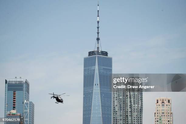 An NYPD helicopter flies overhead above the East River before the start of a group jet ski ride, June 9, 2018 in New York City. Hundreds of...
