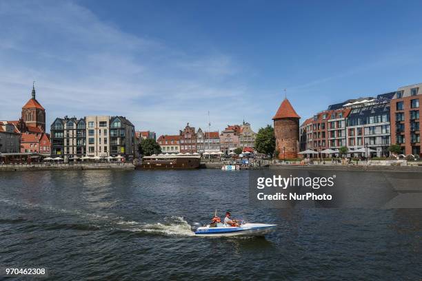 Motor Boat on the Motlawa in front of Hilton hotel is seen in Gdansk, Poland on 9 June 2018