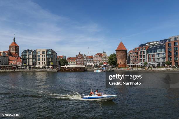 Motor Boat on the Motlawa in front of Hilton hotel is seen in Gdansk, Poland on 9 June 2018