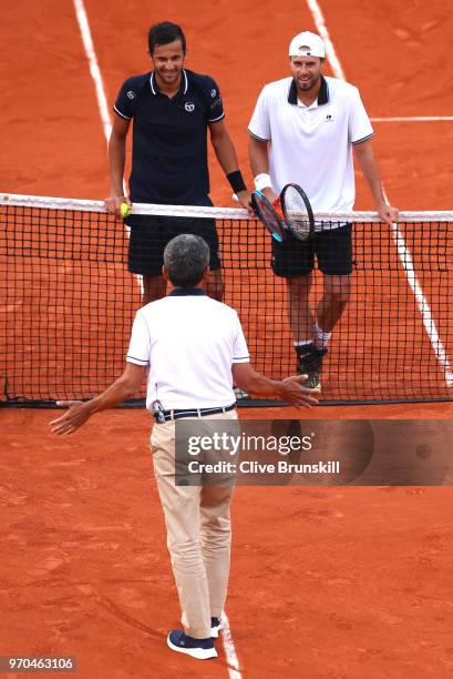 Mate Pavic of Croatia and Oliver Marach of Austria contest a line call during the mens doubles final against Pierre-Hugues Herbert of France and...