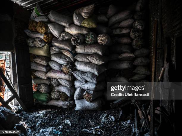 Sacks of charcoal is seen as they make traditional gong instruments at a workshop in Wirun village on June 7, 2018 in Sukoharjo, Central Java,...