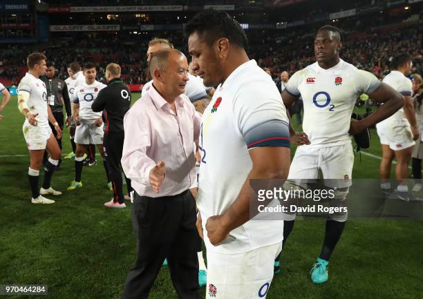 Eddie Jones, the England head coach commersierates with Mako Vunipola, who had been sin binned, after their defeat during the first test match...