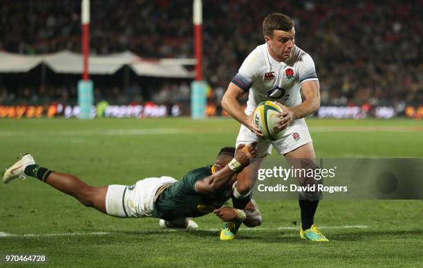 George Ford of England is tackkled by Aphiwe Dyantyi during the first test match between South Africa and England at Elllis Park on June 9, 2018 in...