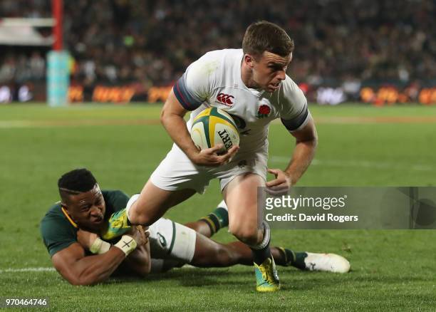 George Ford of England is tackkled by Aphiwe Dyantyi during the first test match between South Africa and England at Elllis Park on June 9, 2018 in...