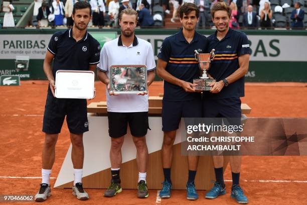 France's Pierre-Hugues Herbert and compatriot Nicolas Mahut pose with the trophy next to second placed Croatia's Mate Pavic and Austria's Oliver...