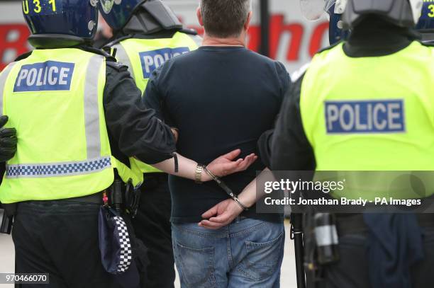 Man is detained by police as supporters of Tommy Robinson protest in Trafalgar Square, London calling for his release from prison.