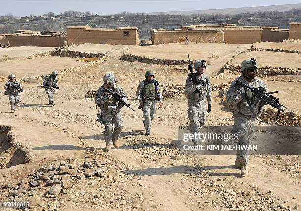 In this February 23, 2010 photograph, US soldiers with the 4th Infantry Division, 4th Infantry Brigade Combat Team, Alpha Company, patrol with an...