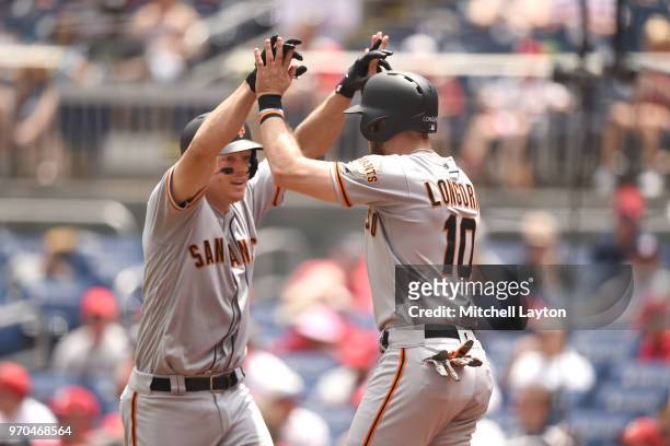 Nick Hundley of the San Francisco Giants celebrates a three run home run with Evan Longoria of the San Francisco Giants in the third inning during a...