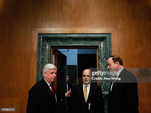 Federal Reserve Board Chairman Ben Bernanke is greeted by Committee Chairman Sen. Christopher Dodd and ranking member Sen. Richared Shelby as he...