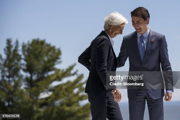Justin Trudeau, Canada's prime minister, right, and Christine Lagarde, managing director of the International Monetary Fund , laugh while arriving...