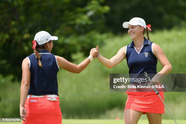 Kristen Gillman and Jennifer Kupcho of the United States team celebrate a putt for birdie on the 15th green as they play against Olivia Mehaffey and...