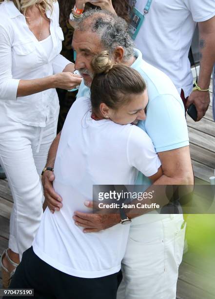 Winner Simona Halep of Romania is congratulated by Ion Tiriac following the French Open final on Day 14 of the 2018 French Open at Roland Garros...