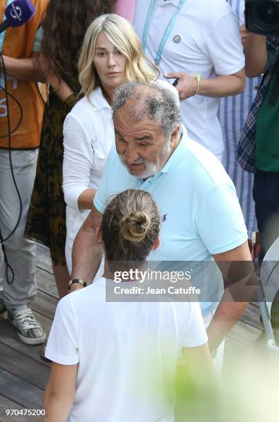 Winner Simona Halep of Romania is congratulated by Ion Tiriac and Nadia Comaneci following the French Open final on Day 14 of the 2018 French Open at...