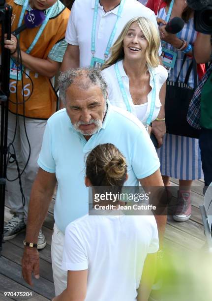 Winner Simona Halep of Romania is congratulated by Ion Tiriac and Nadia Comaneci following the French Open final on Day 14 of the 2018 French Open at...