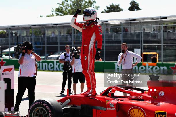 Pole position qualifier Sebastian Vettel of Germany and Ferrari celebrates in parc ferme during qualifying for the Canadian Formula One Grand Prix at...