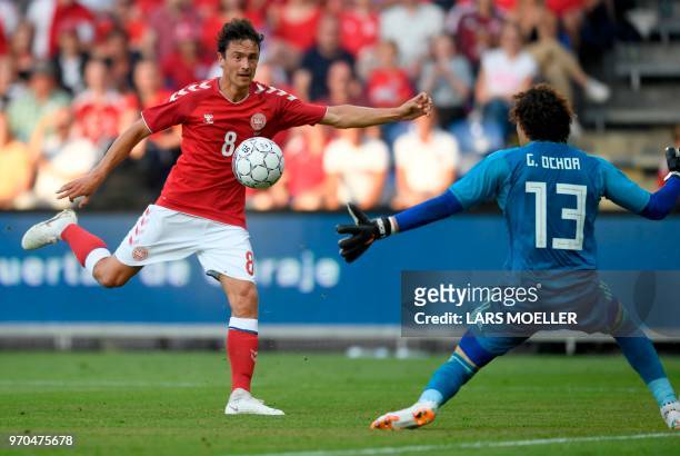 Denmark's Thomas Delaney attempts to score against Mexico's goalkeeper Guillermo Ochoa during the international friendly footbal match Denmark vs...