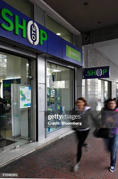 Pedestrians walk past a Hellenic Telecommunications Organization SA store in Athens, Greece, on Thursday, Feb. 25, 2010. Hellenic Telecommunications...