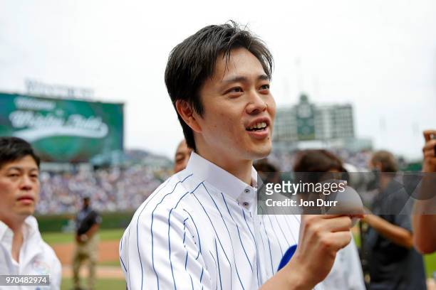 Hirofumi Yoshimura, mayor of Osaka, Japan, talks with media after throwing out a ceremonial first pitch before the game between the Chicago Cubs and...