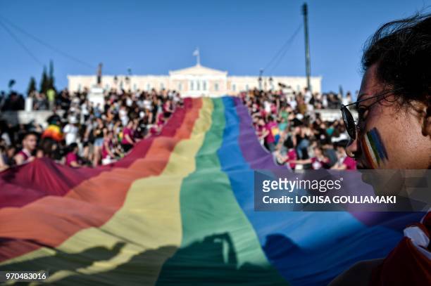 Huge rainbow flag is seen in front of the greek parliament in Athens during the annual Gay Pride Parade on June 9, 2018. - Thousands of people took...