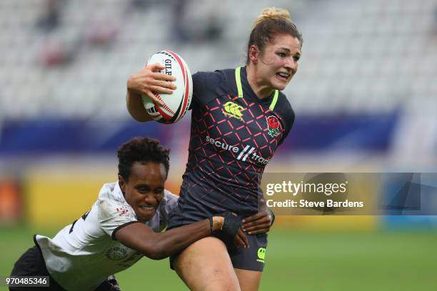 Amy Wilson Hardy of England is tackled by Timaima Rosi Lulutai Ravisa of Fiji during the Women's 5th place semi final between Fiji and England during...